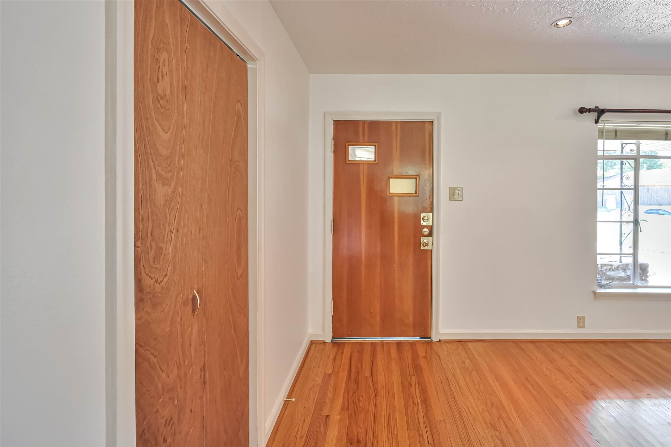 3018 Attridge Road Houston, TX 77018 - Photo 12 of 29 an empty room with wooden floor and windows