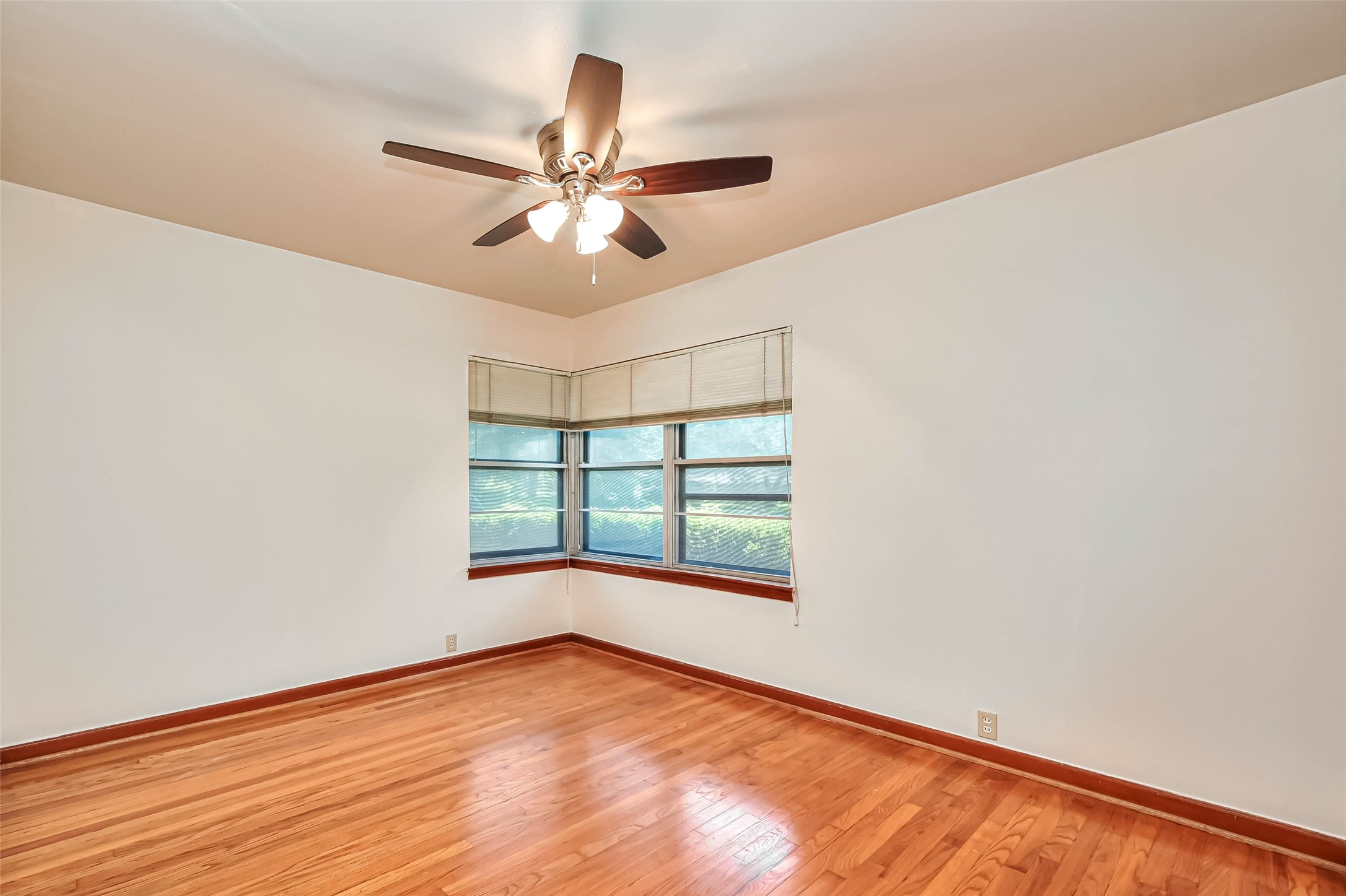 3018 Attridge Road Houston, TX 77018 - Photo 21 of 29 an empty room with wooden floor fan and windows
