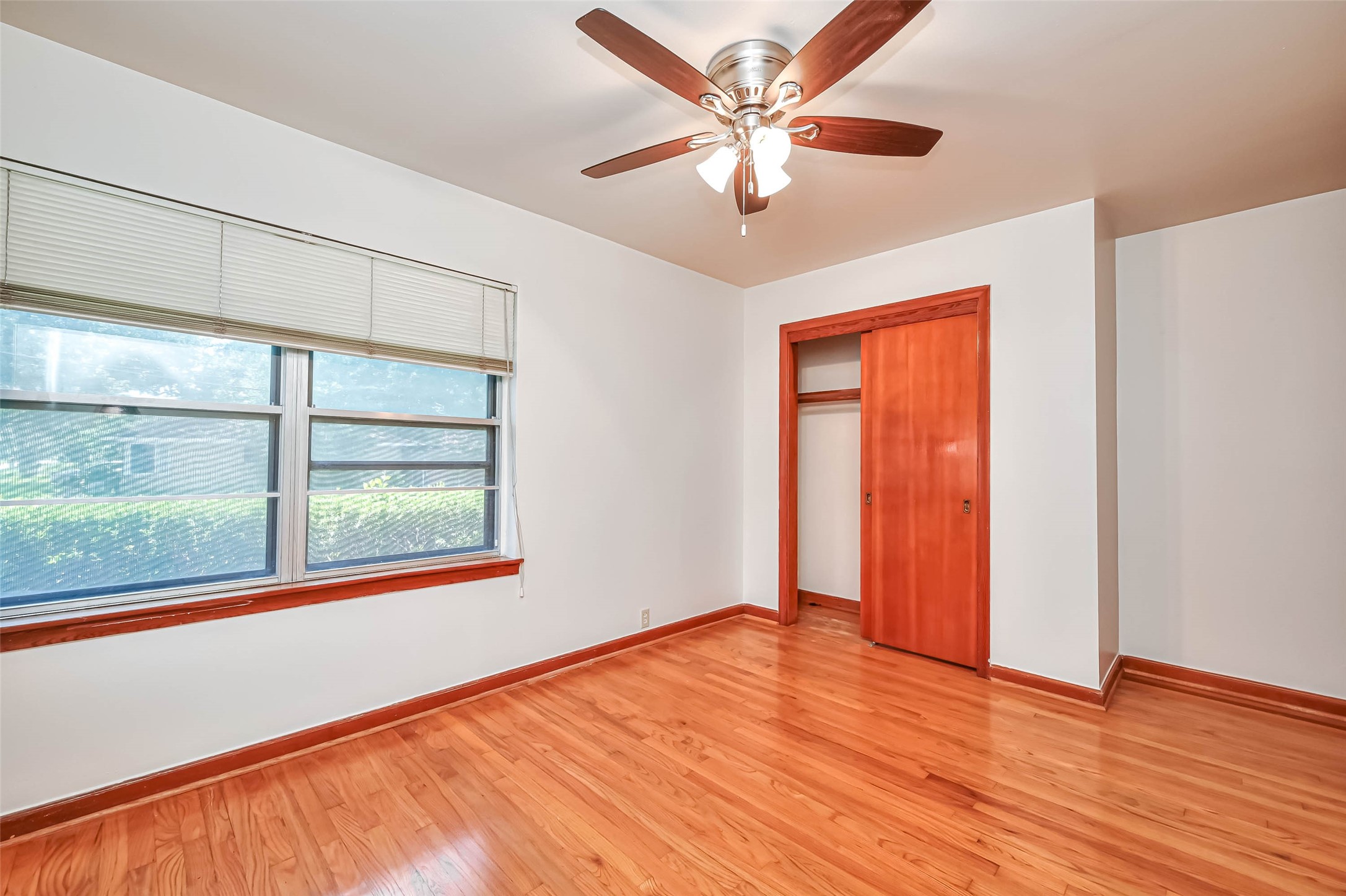 3018 Attridge Road Houston, TX 77018 - Photo 22 of 29 an empty room with wooden floor chandelier and fan