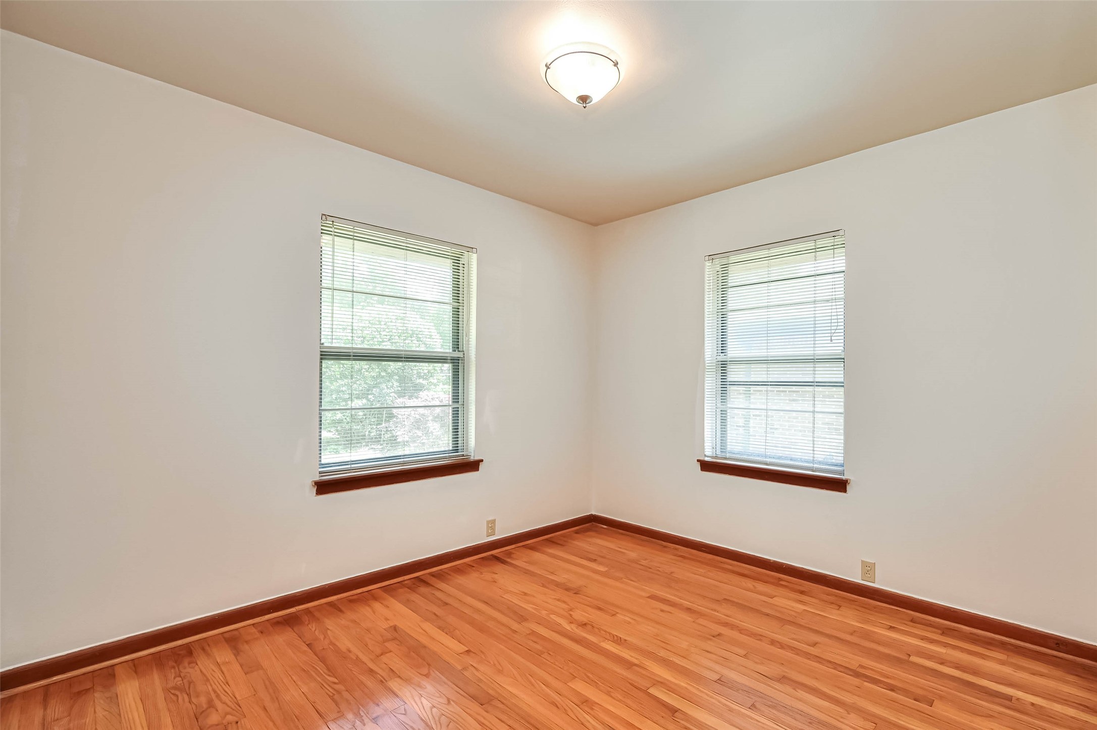3018 Attridge Road Houston, TX 77018 - Photo 24 of 29 an empty room with wooden floor and windows