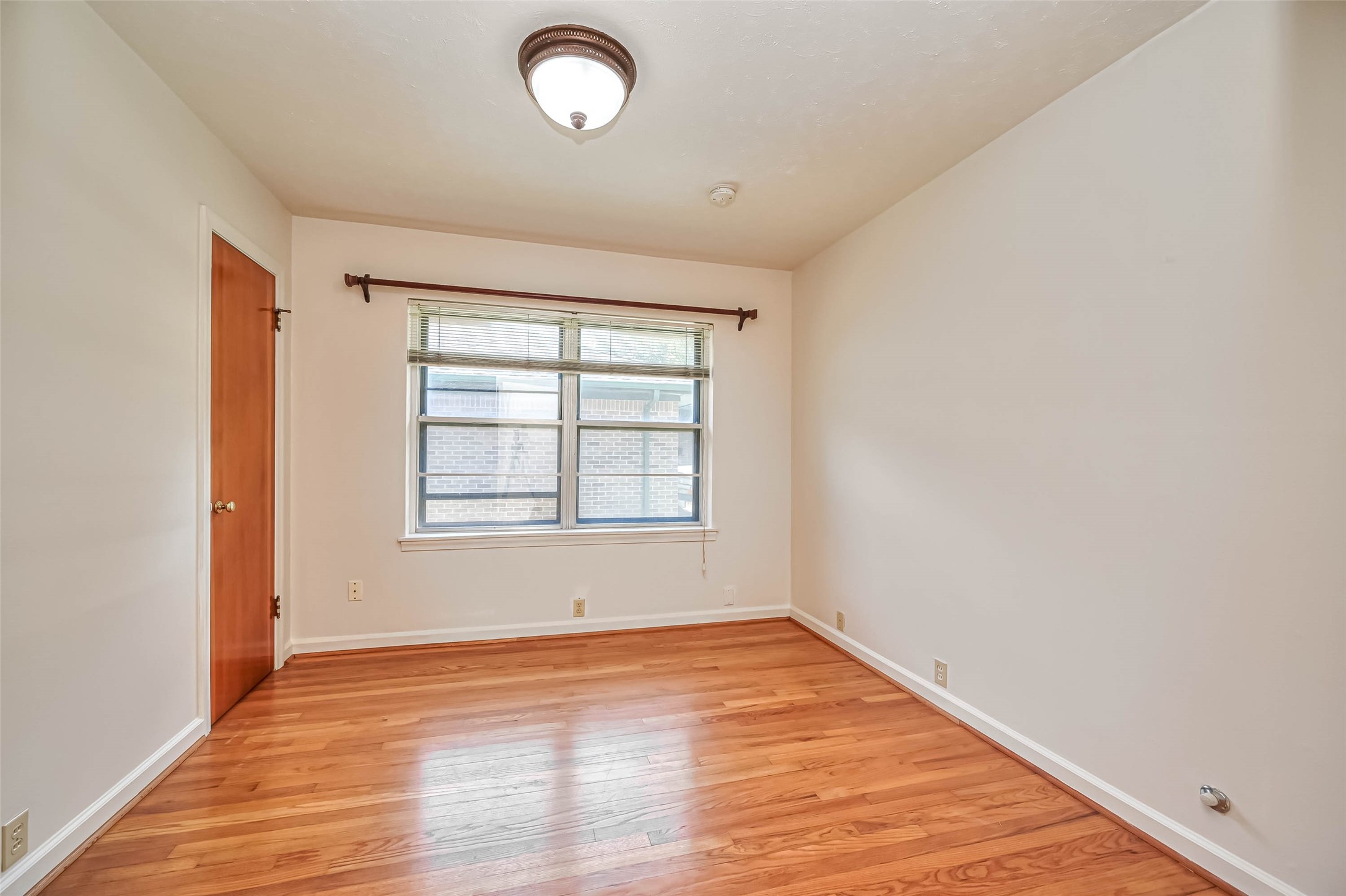 3018 Attridge Road Houston, TX 77018 - Photo 25 of 29 an empty room with wooden floor and windows