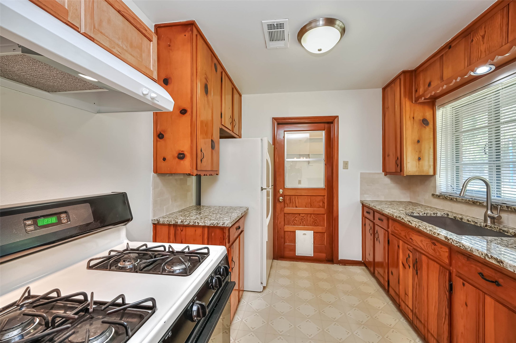 3018 Attridge Road Houston, TX 77018 - Photo 7 of 29 a kitchen with a stove and a sink