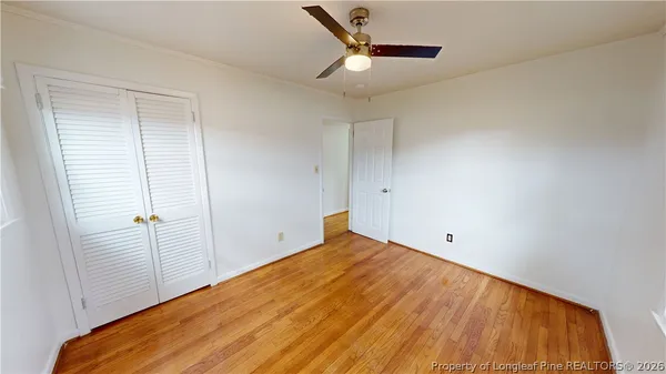 a view of a room with wooden floor and white walls