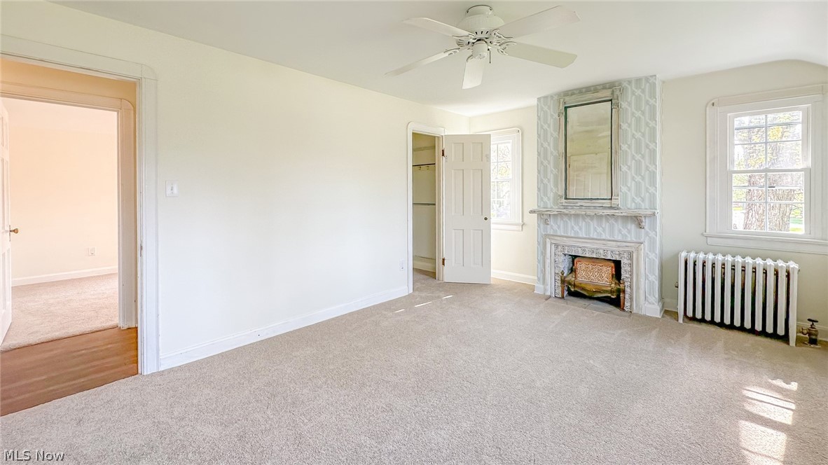 25819 Center Ridge Road Westlake, OH 44145 - Photo 18 of 45 Master bedroom featuring natural light, new carpet flooring, and a fireplace
