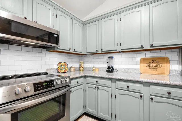 a bathroom with a granite countertop sink toilet and a mirror