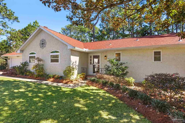 a living room with furniture a fireplace and a ceiling fan