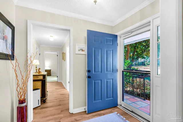 a living room with furniture a rug and a chandelier