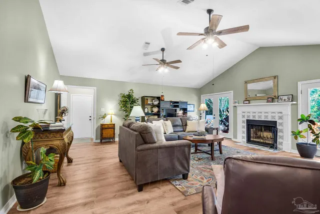 a living room with a fireplace and a potted plant