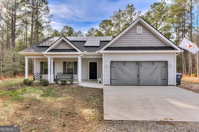 a front view of a house with yard and outdoor seating