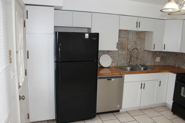 a kitchen with a sink and refrigerator