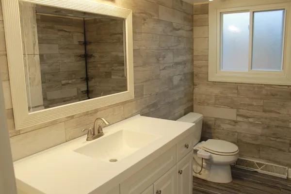 a bathroom with a sink toilet and shower