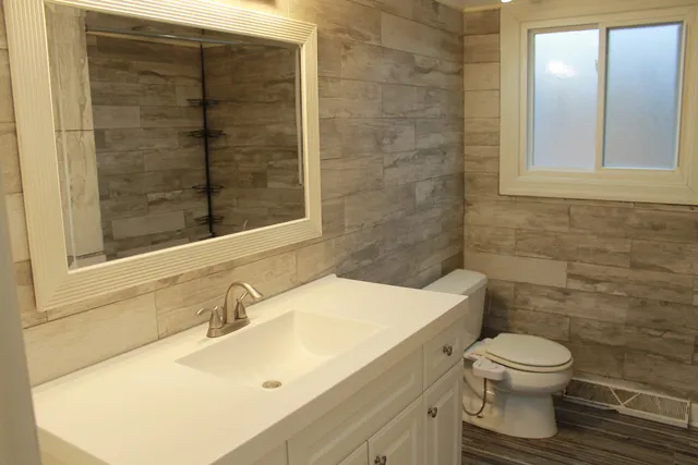 a bathroom with a sink toilet and shower