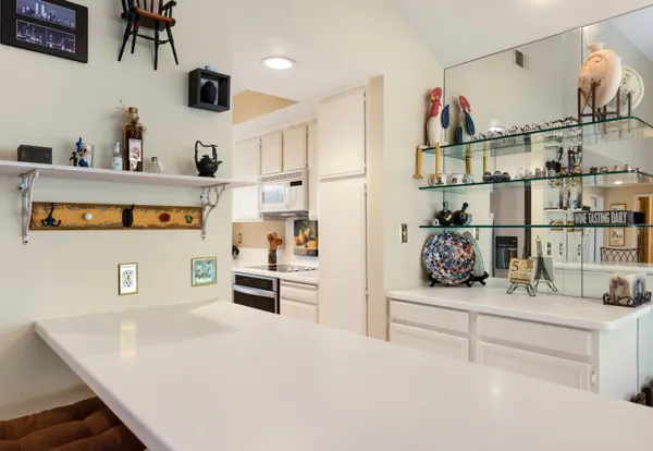 a kitchen with stainless steel appliances kitchen island granite countertop a sink and cabinets