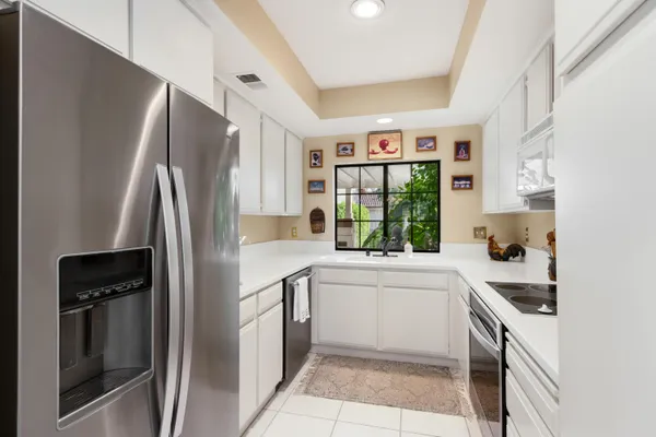 a kitchen with a refrigerator and a sink
