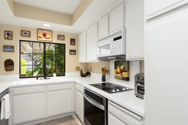 a kitchen with stainless steel appliances white cabinets and a stove