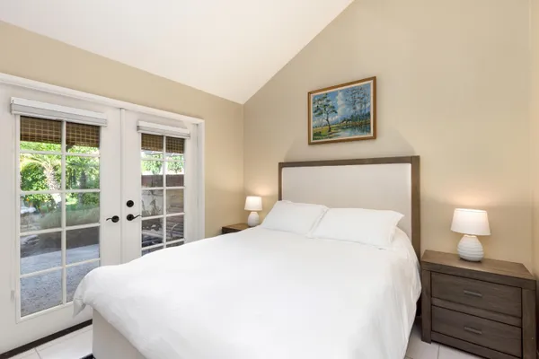 a bedroom with a large bed and a window