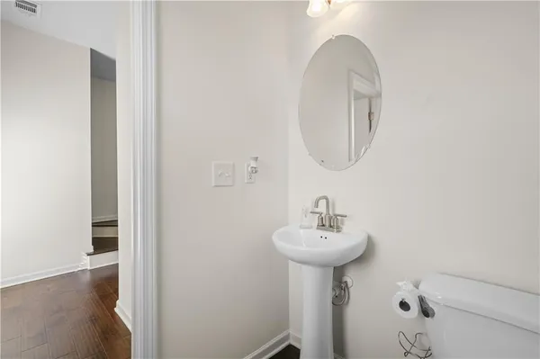a bathroom with a sink a mirror and a toilet