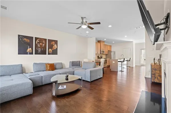 a living room with furniture and a wooden floor