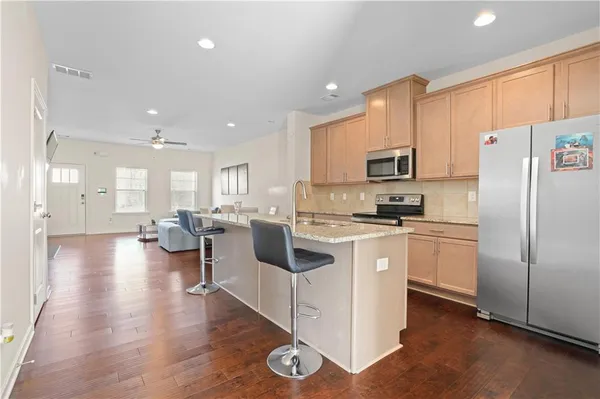 a kitchen with white cabinets and stainless steel appliances