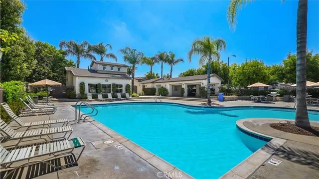 a patio with a table and chairs and potted plants
