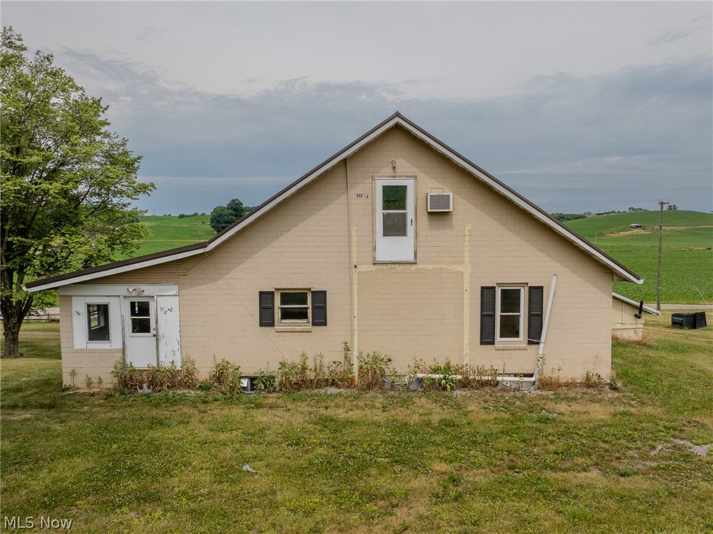 View of side of property with a yard