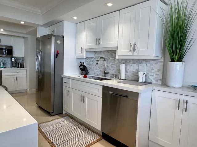 a kitchen with a sink stainless steel appliances and cabinets