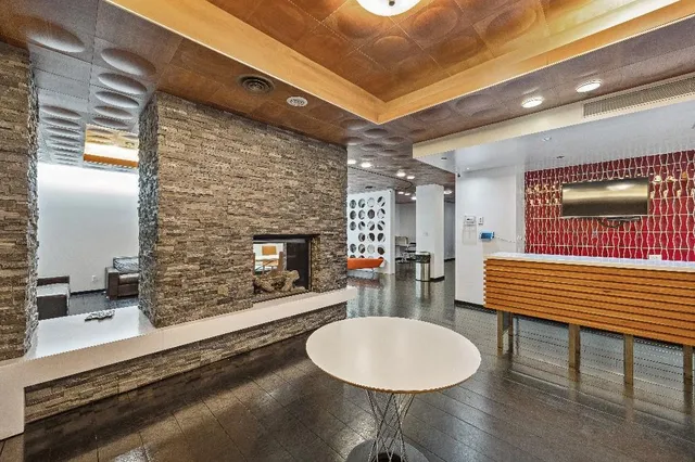 a room with dining table and a fireplace