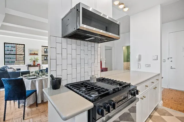 a stove top oven sitting inside of a kitchen