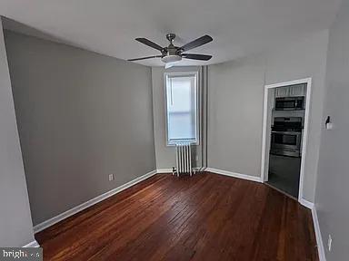 3175 Tulip Street Philadelphia, PA 19134 - Photo 5 of 12 wooden floor in an empty room with a window