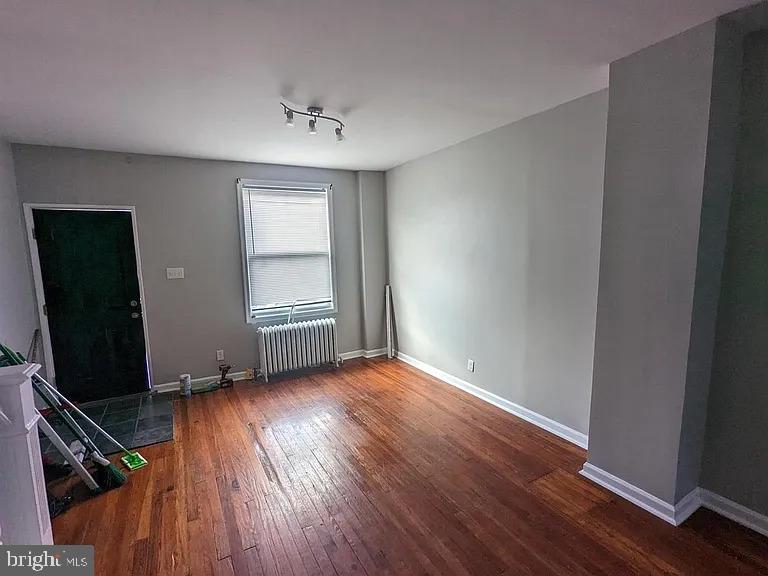 3175 Tulip Street Philadelphia, PA 19134 - Photo 6 of 12 an empty room with wooden floor and windows