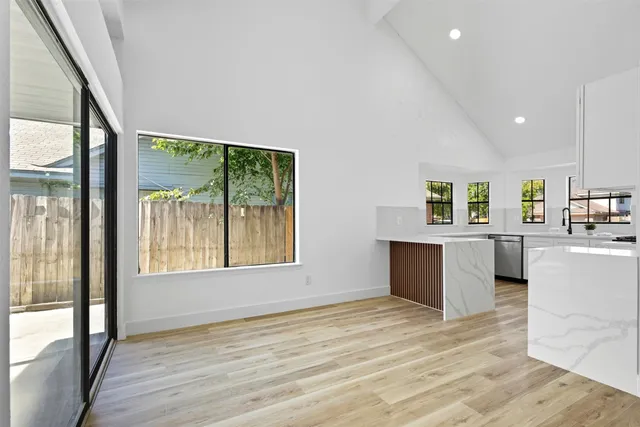 a view of a kitchen with wooden floor and a kitchen