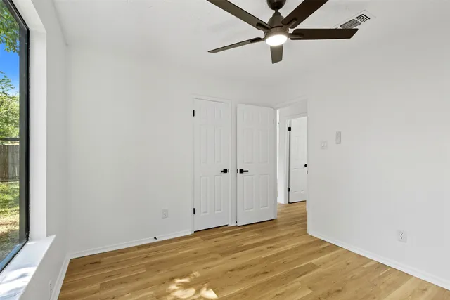 a view of a room with a ceiling fan