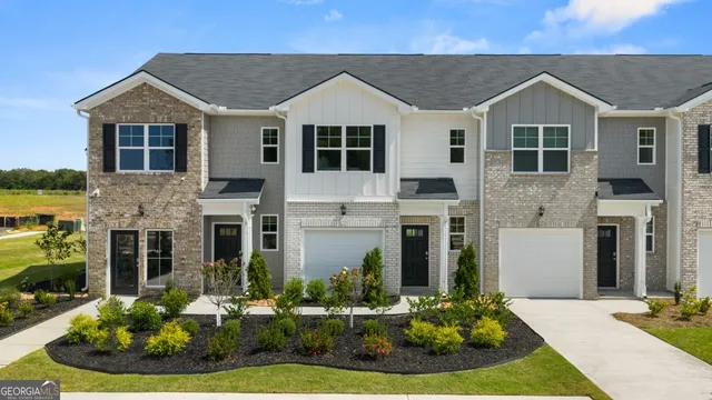 a front view of a house with a yard table and chairs