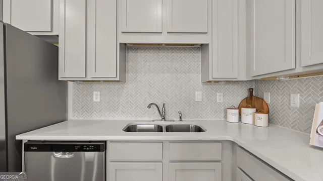 a kitchen with stainless steel appliances a stove a sink and a microwave