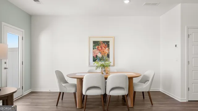 a dining room with furniture and potted plant