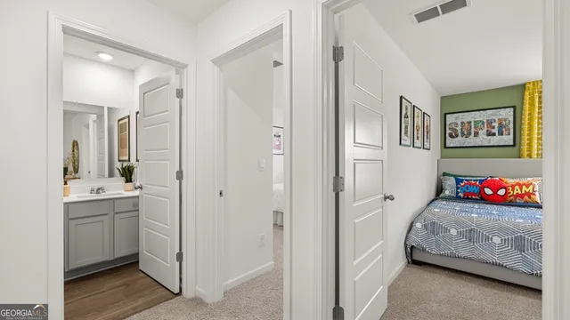a bedroom with a bed lamp and a large window