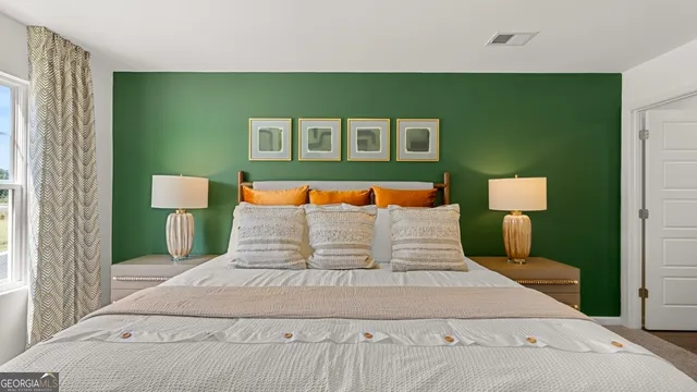 a bedroom with a bed and a lamp on table