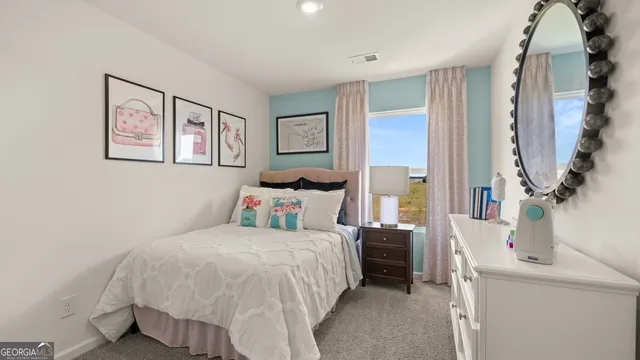 a bedroom with a bed and a dresser