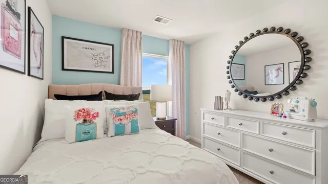 a bedroom with a bed and wall painting