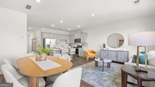 a kitchen with stainless steel appliances a refrigerator stove microwave and cabinets