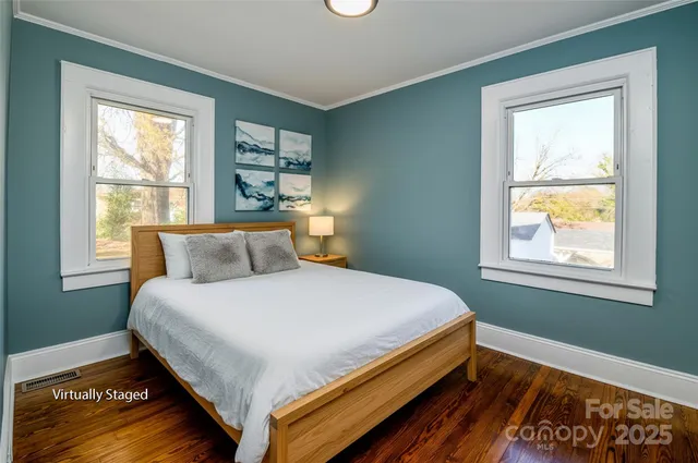 a bed sitting in a bedroom next to a window