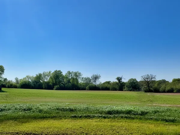 a view of a lake with a big yard