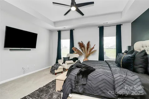 a bedroom with a bed window and flat screen tv