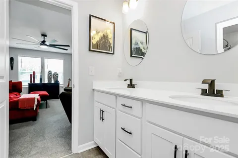 a en suite bathroom with a double vanity sink and a mirror