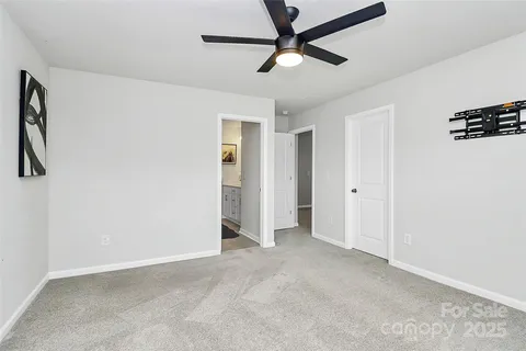 a view of a livingroom with a ceiling fan and window