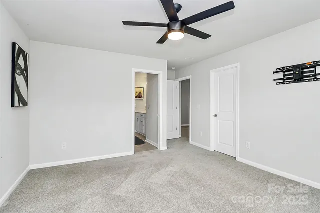a view of a livingroom with a ceiling fan and window