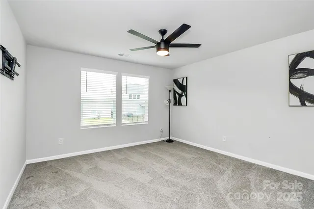 a view of a livingroom with a ceiling fan and window