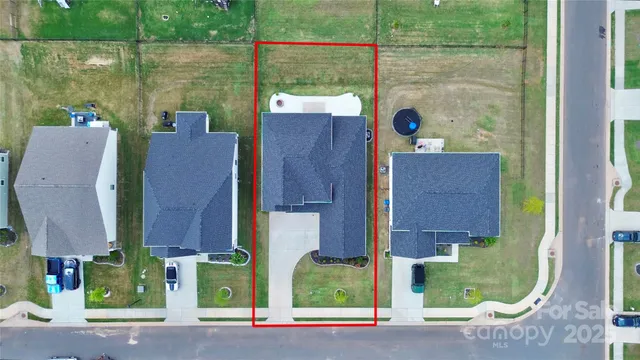 a sign that is sitting in front of a big yard