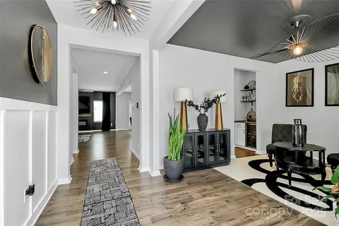 a view of a hallway with couch and wooden floor