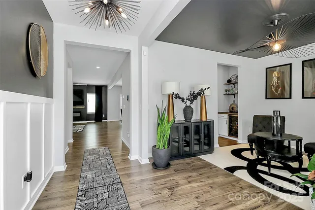 a view of a hallway with couch and wooden floor